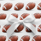 Football wrapping paper with a white satin bow, perfect for a sports fan's gift.