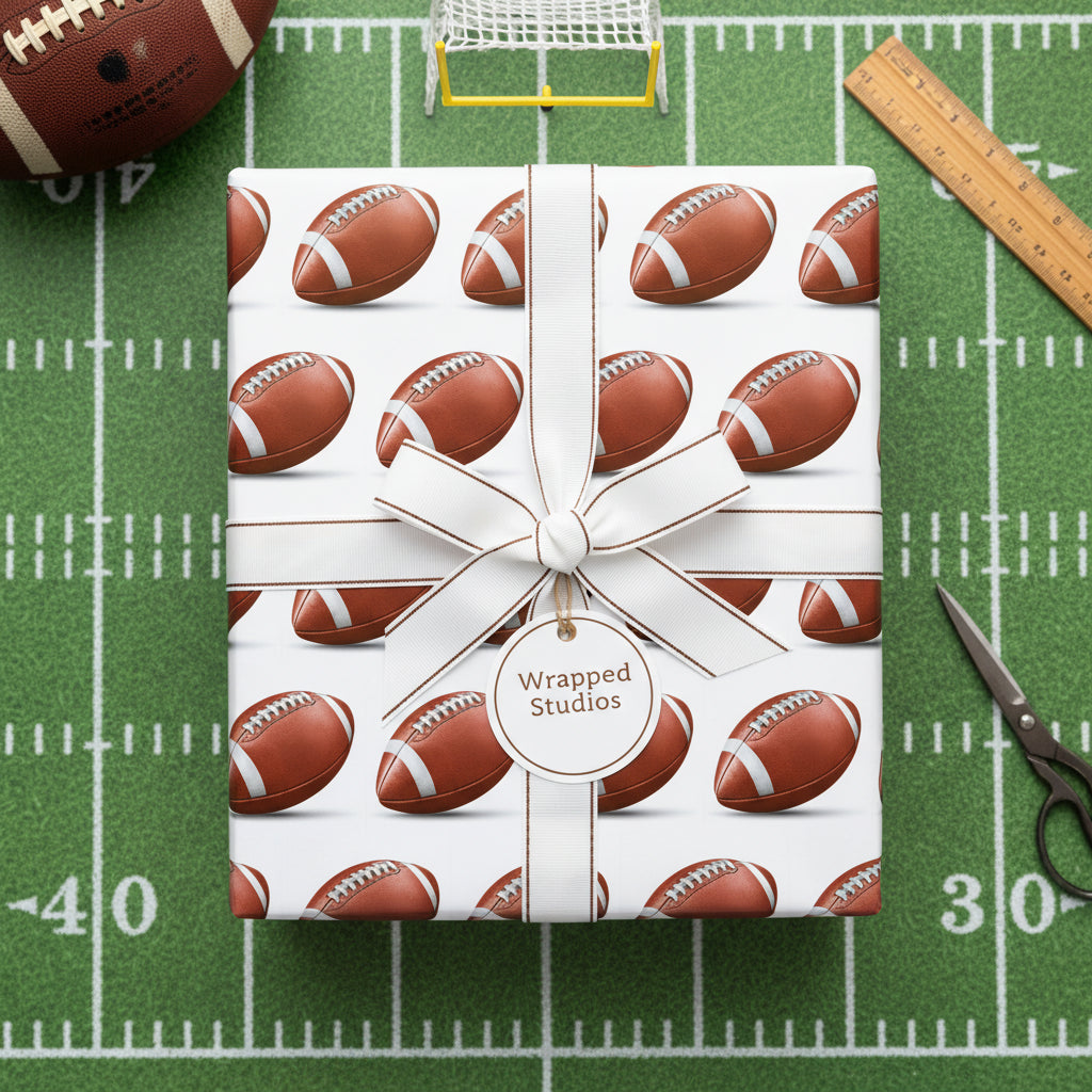 Wrapped Studios football wrapping paper with white ribbon on a football field backdrop.