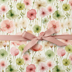 Gift box wrapped in elegant floral wrapping paper with a blush-colored satin ribbon.