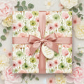 Elegant floral wrapping paper with a satin ribbon and bow, perfect for birthday gifts.