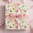 Gift box wrapped in floral wrapping paper with a pink sheer ribbon and bow.