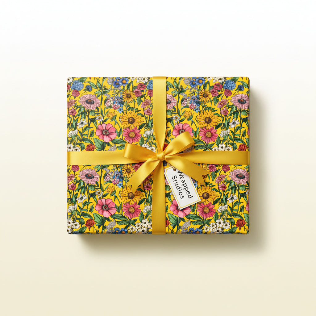 Gift wrapped in vibrant yellow floral wrapping paper with matching satin bow and a tag.
