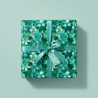 Square gift wrapped in clover floral wrapping paper with matching ribbon, perfect for St. Patrick's Day.