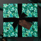 Square gift wrapped in clover print St. Patrick's Day wrapping paper with black velvet ribbon and "Luck o' the Irish" tag.