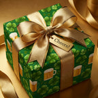 St. Patrick's Day wrapping paper with shamrocks and beer mugs, gold bow, and Cheers tag. Wrapped Studios.