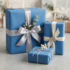 Elegant blue gift wrapping paper with silver ribbon and botanical accents for birthdays, weddings, or special occasions.