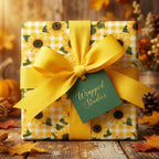 Fall sunflower wrapping paper on yellow gingham with a large yellow bow by Wrapped Studios.