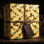 Rustic sunflower wrapping paper with yellow gingham pattern and twine bow by Wrapped Studios.