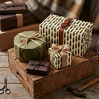Rustic bullet pattern wrapping paper on masculine gifts with twine bows by Wrapped Studios.