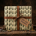 Ammunition wrapping paper with bullet pattern and leather strap, rustic hunter gift wrap by Wrapped Studios.
