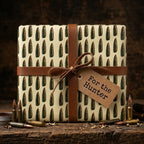 Ammunition wrapping paper with bullet pattern and leather strap, rustic hunter gift wrap by Wrapped Studios.