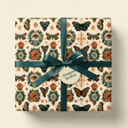 Mystical butterfly wrapping paper with vintage eye motifs and a teal satin ribbon by Wrapped Studios.