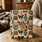 Vintage gothic wrapping paper with butterfly and eye patterns, tied with twine by Wrapped Studios.