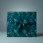 Teal floral wrapping paper on a square gift box tied with a satin ribbon.