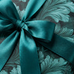 Teal botanical wrapping paper with a matching satin ribbon bow, luxury gift wrap by Wrapped Studios.