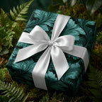 Luxury emerald teal botanical wrapping paper with white satin bow on gift box, by Wrapped Studios.