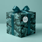 Luxury teal botanical wrapping paper by Wrapped Studios, featuring an elegant floral pattern and satin bow.