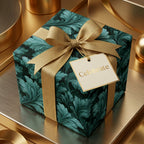 Luxury emerald green botanical wrapping paper with a gold ribbon and gift tag by Wrapped Studios.