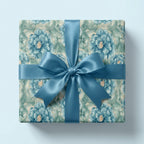 Luxury blue floral wrapping paper by Wrapped Studios, featuring an elegant gift box tied with a teal satin bow.