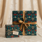 Elegant dark green floral wrapping paper with red and gold accents, tied with a luxurious gold ribbon, perfect for special occasion gift wrap.