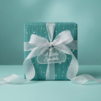 Teal gift wrap with a white starburst pattern, tied with a sheer ribbon and cloud-shaped "A Little Sparkle" tag.