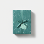 Teal gift box wrapped in modern patterned wrapping paper with ribbon and tag, for birthdays and special occasions.
