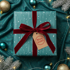 Teal Christmas gift wrap with velvet ribbon and 'Merry Wishes' tag surrounded by festive ornaments.