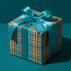Teal and orange plaid wrapping paper with a matching satin bow on a gift box, by Wrapped Studios.