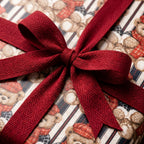 Teddy bear Christmas wrapping paper tied with a red herringbone ribbon bow by Wrapped Studios.