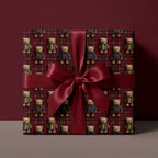 Vintage teddy bear Christmas wrapping paper with a burgundy satin bow on a gift box by Wrapped Studios.