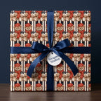 Teddy bear Christmas wrapping paper on a gift box with a navy blue bow, by Wrapped Studios.