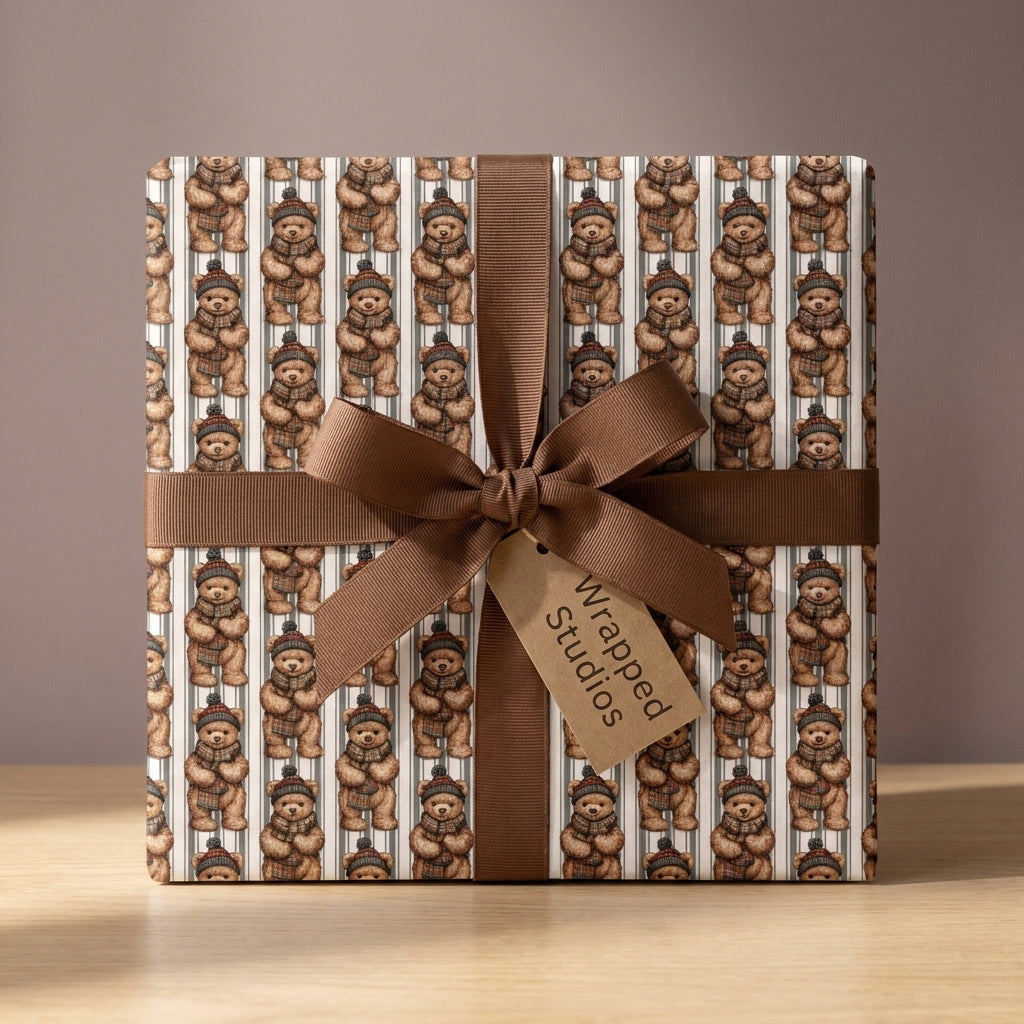 Cute teddy bear wrapping paper with a brown ribbon bow on a holiday gift box by Wrapped Studios.