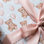 Blue teddy bear baby shower wrapping paper with pink balloons and a satin ribbon by Wrapped Studios.