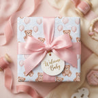 Pastel teddy bear baby shower wrapping paper with pink ribbon and Welcome Baby tag by Wrapped Studios.