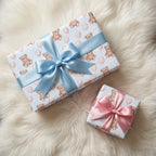 Teddy bear baby shower wrapping paper with blue and pink bows on white fur, by Wrapped Studios.