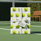 Wrapped Studios tennis ball print wrapping paper with a white ribbon and bow.