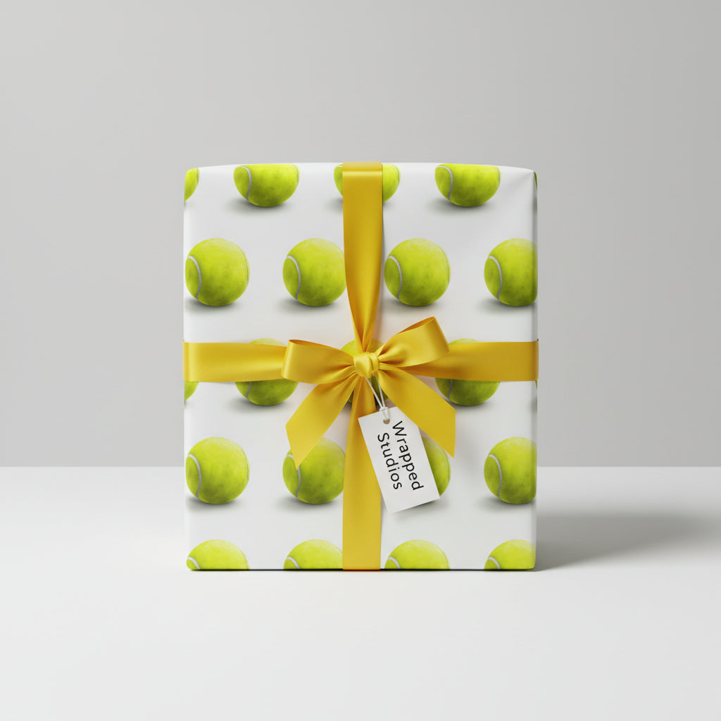 Wrapped Studios tennis ball wrapping paper with gold ribbon; unique gift wrap for sports fans.