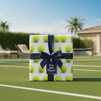 Tennis ball wrapping paper, navy ribbon, and "New Ball Please!" tag. Wrapped Studios.