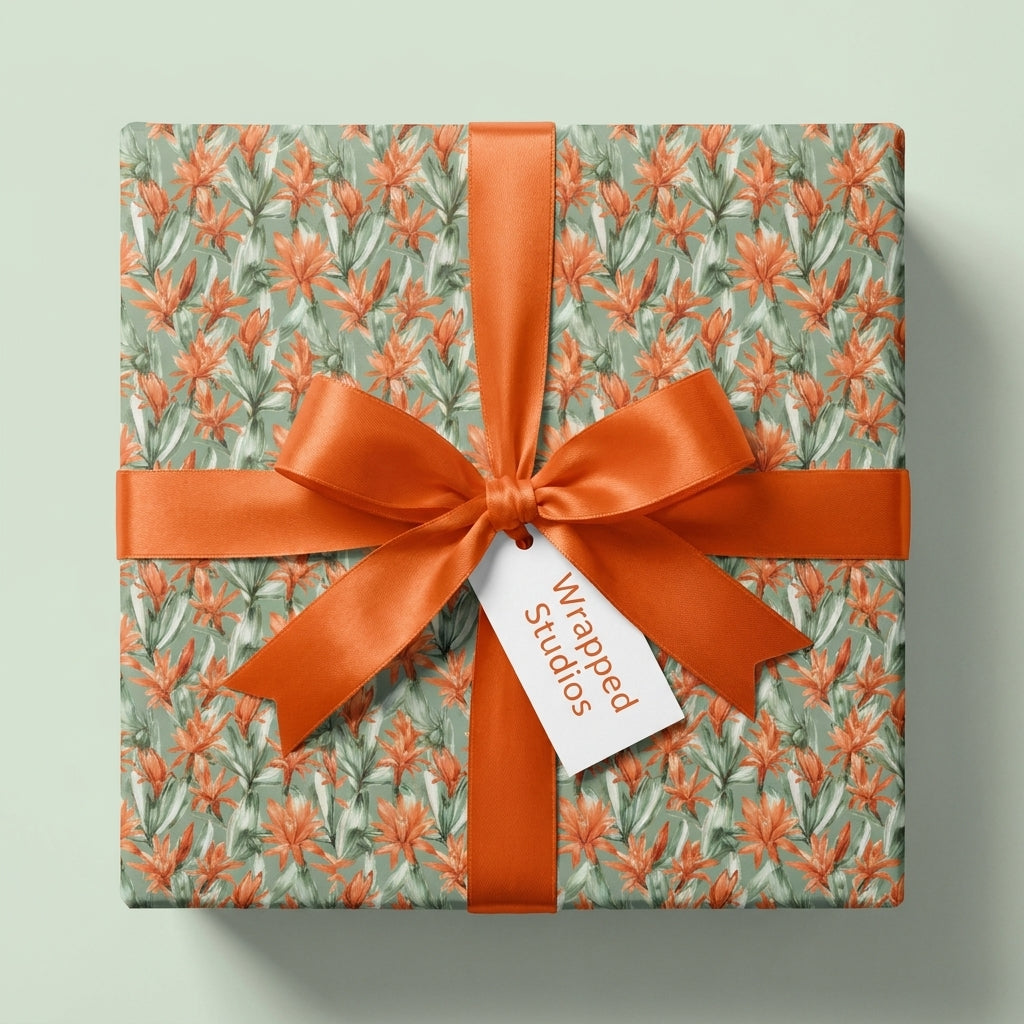Luxury sage green and orange floral wrapping paper with a satin ribbon bow, by Wrapped Studios.