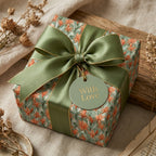 Vintage floral wrapping paper in sage green with a luxury satin bow and gift tag by Wrapped Studios.