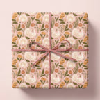 Thanksgiving wrapping paper with vintage turkey and pumpkin pattern, tied with a pink bow by Wrapped Studios.