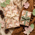 Thanksgiving wrapping paper with turkeys and pumpkins on cozy autumn gifts by Wrapped Studios.