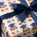 Cute tiger graduation wrapping paper with a navy blue satin bow by Wrapped Studios.