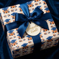 Tiger graduation wrapping paper with a navy blue bow and congrats grad tag by Wrapped Studios.