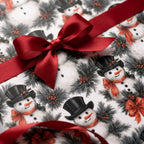 Vintage snowman Christmas wrapping paper with a red satin ribbon bow, by Wrapped Studios.