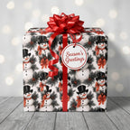 Snowman Christmas wrapping paper with a red bow and Season’s Greetings tag by Wrapped Studios.