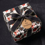 Snowman Christmas gift wrap with luxury black velvet ribbon and No Peeking tag by Wrapped Studios.