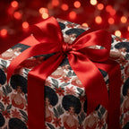 Christmas gift wrap featuring African American women art and a red satin bow by Wrapped Studios.