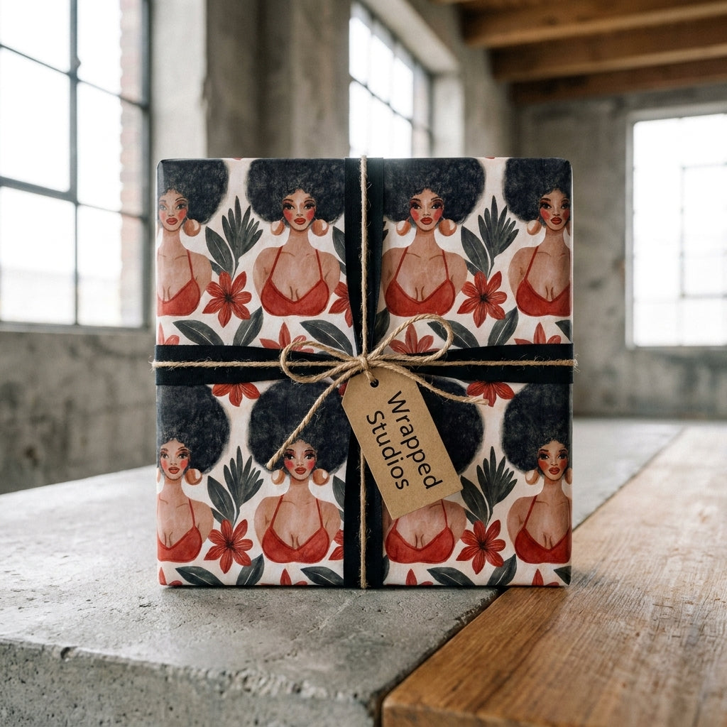Afrocentric wrapping paper featuring Black women on a gift box with a Wrapped Studios tag.