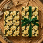 Tropical banana wrapping paper by Wrapped Studios, tied with a green velvet ribbon on a woven tray.